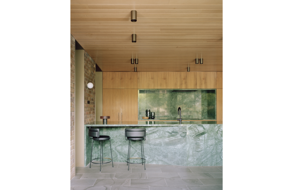 The modern kitchen blends brick, marble, bluestone and timber with finesse.